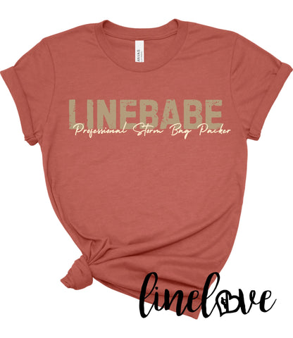 Clay colored tee with the word LINEBABE in tan and professional storm bag packer in cream